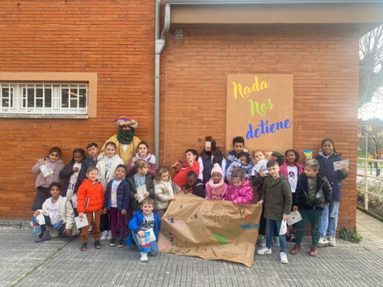 Niños y niñas con Aliatar delante de un colegio